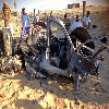 Egyptians gather near a damaged car bomb that detonated before reaching the intended target killing three passengers in El-Arish .24-7- 2013 